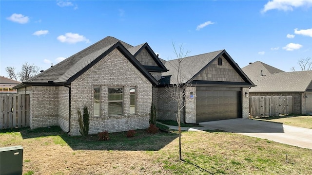 view of front facade featuring brick siding, fence, concrete driveway, and an attached garage