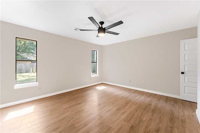 empty room with ceiling fan, visible vents, baseboards, and light wood-style flooring