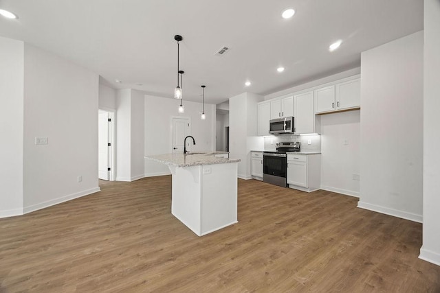 kitchen featuring a sink, visible vents, light wood-style floors, and appliances with stainless steel finishes