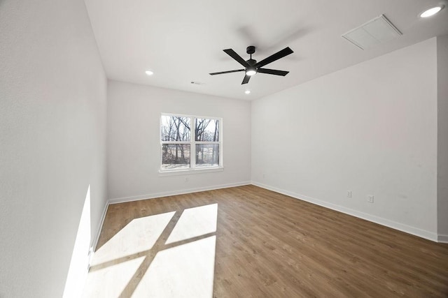 empty room with recessed lighting, visible vents, baseboards, and wood finished floors