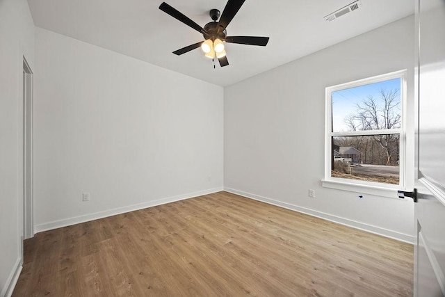 unfurnished room featuring light wood-style flooring, baseboards, visible vents, and ceiling fan