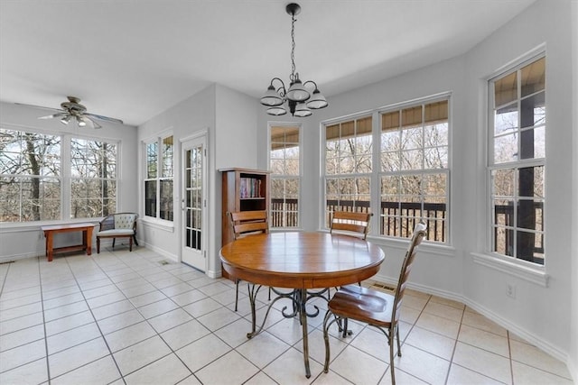 dining room featuring light tile patterned floors, ceiling fan with notable chandelier, and baseboards