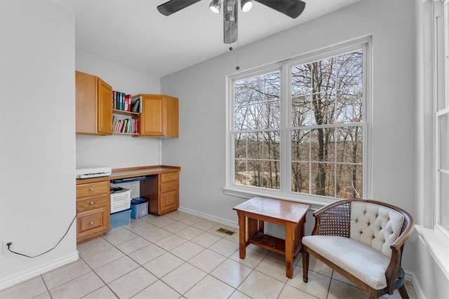 office area with light tile patterned flooring, visible vents, baseboards, and a ceiling fan