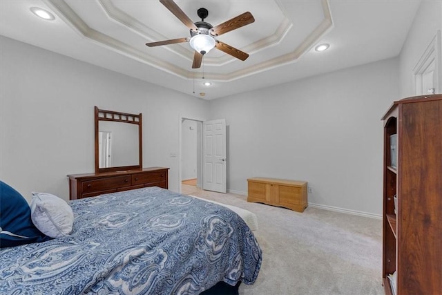 bedroom with baseboards, a tray ceiling, ornamental molding, carpet floors, and a ceiling fan