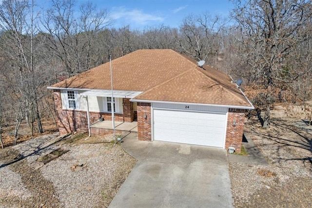 ranch-style house with brick siding, an attached garage, and concrete driveway