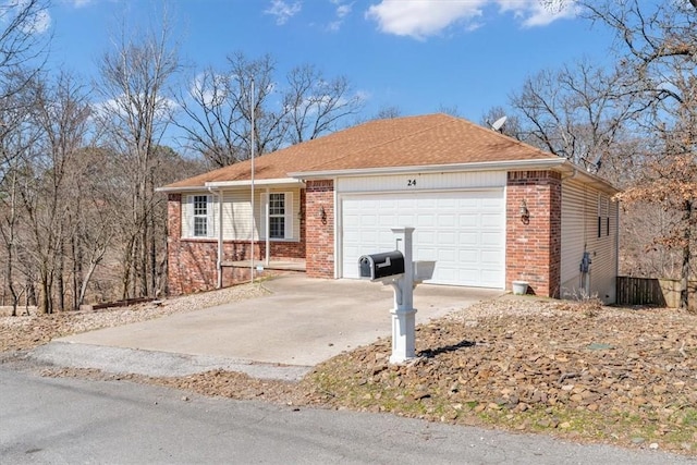 ranch-style home featuring a garage, brick siding, and concrete driveway