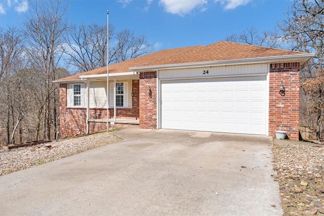 ranch-style house with concrete driveway, an attached garage, brick siding, and roof with shingles