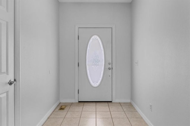 foyer entrance with light tile patterned floors and baseboards