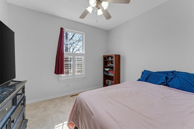 bedroom featuring a ceiling fan, visible vents, light colored carpet, and baseboards