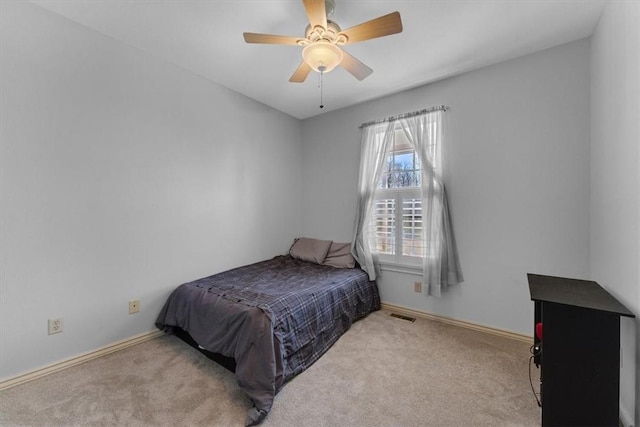 carpeted bedroom featuring visible vents, a ceiling fan, and baseboards