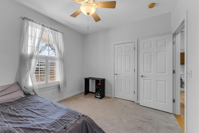 bedroom featuring ceiling fan, baseboards, and light carpet