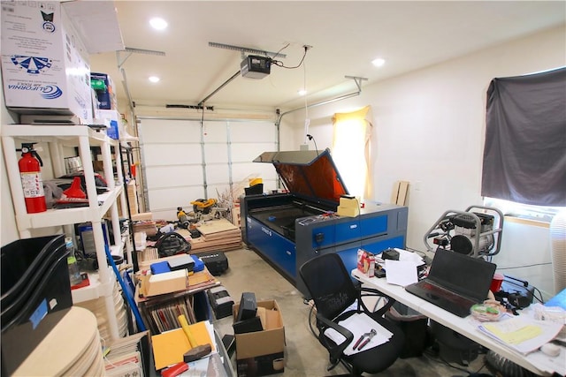 garage with recessed lighting and a garage door opener