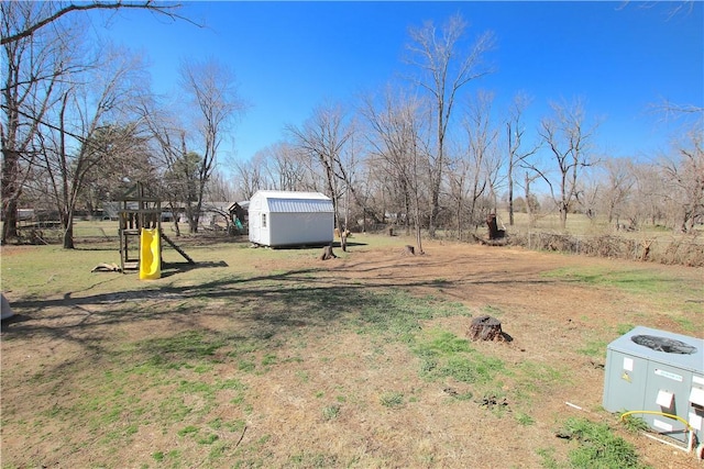 view of yard with an outdoor structure and a shed