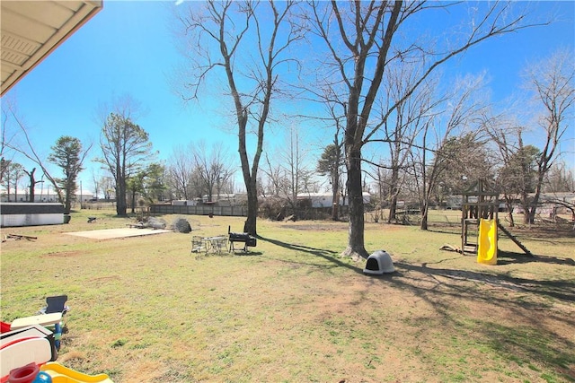 view of yard with playground community and fence