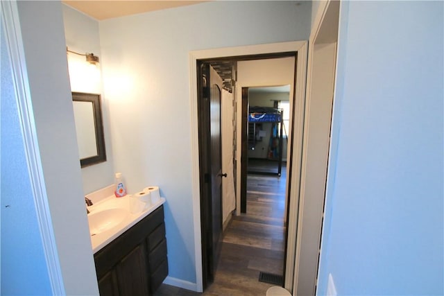 bathroom with vanity and wood finished floors