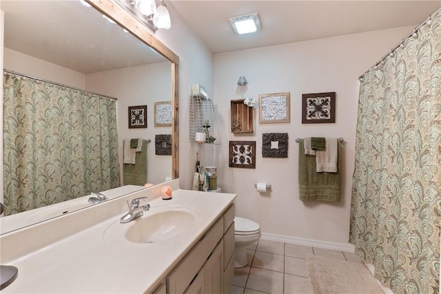 full bathroom featuring tile patterned flooring, toilet, vanity, and baseboards