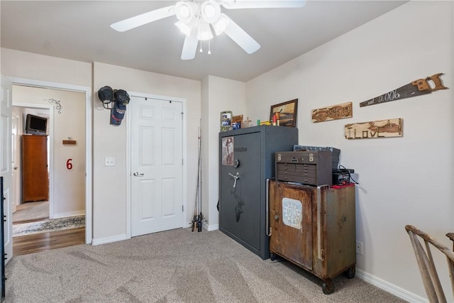 interior space with carpet, baseboards, and ceiling fan