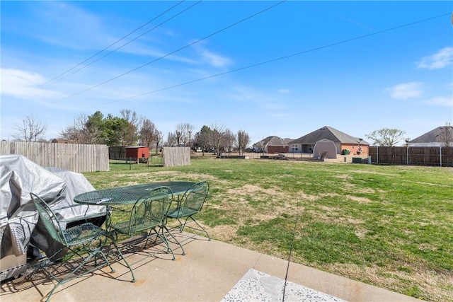 view of yard with a patio area, outdoor dining area, and fence