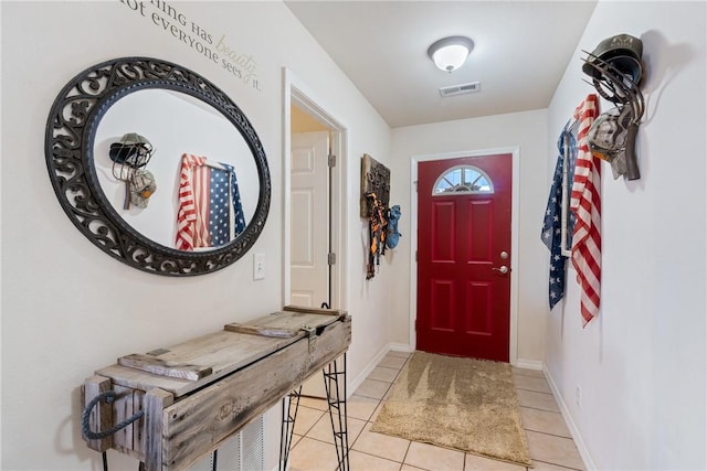 entrance foyer featuring light tile patterned floors, visible vents, and baseboards