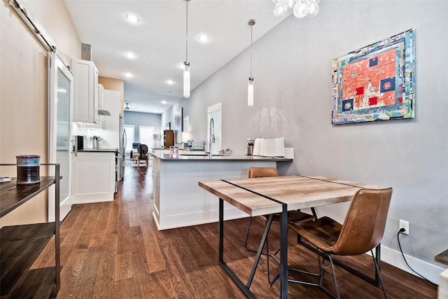 dining space with recessed lighting, baseboards, and dark wood-style flooring