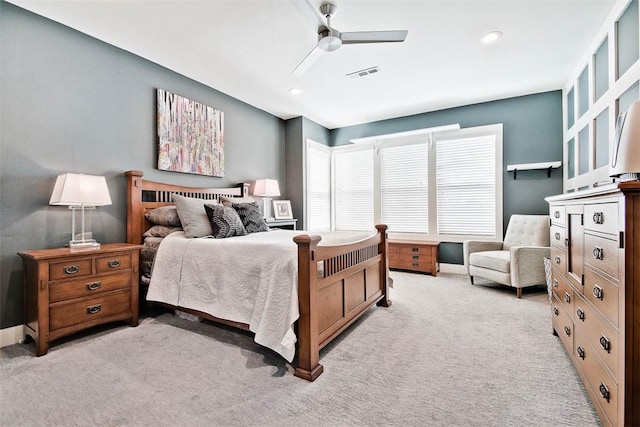 bedroom featuring baseboards, a ceiling fan, visible vents, and light carpet