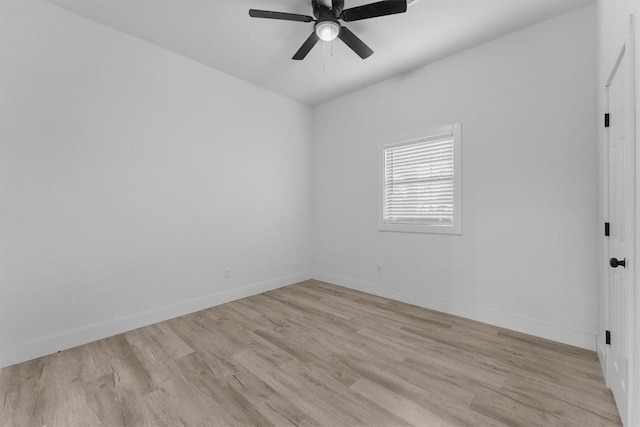 spare room with light wood-style flooring, baseboards, and ceiling fan