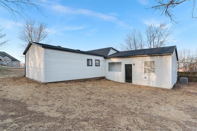 rear view of property with central AC