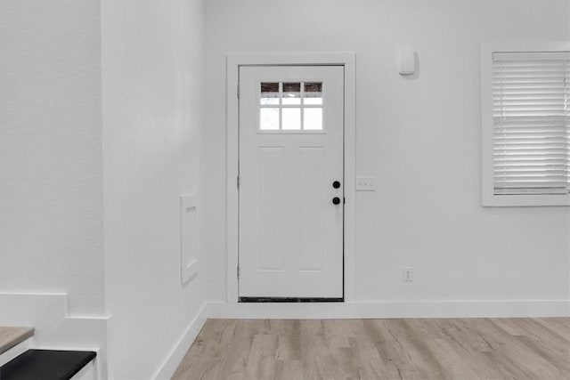 foyer featuring baseboards and light wood-type flooring