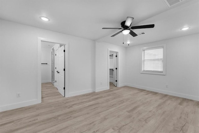 unfurnished bedroom featuring recessed lighting, baseboards, light wood-style floors, and a spacious closet