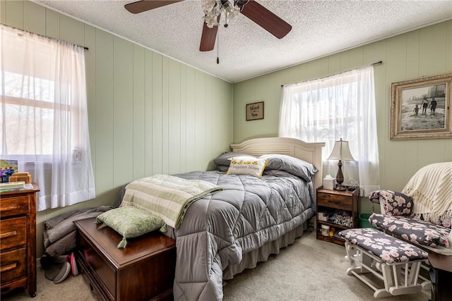 bedroom with carpet flooring, a textured ceiling, and ceiling fan