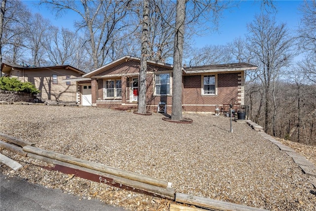 view of front of home featuring brick siding and an attached garage