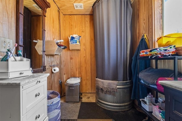 interior space with wooden walls and visible vents