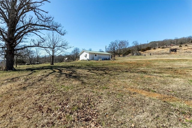 view of yard with a rural view