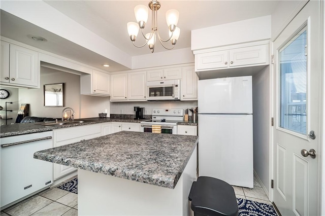 kitchen featuring a sink, white appliances, an inviting chandelier, white cabinets, and light tile patterned flooring