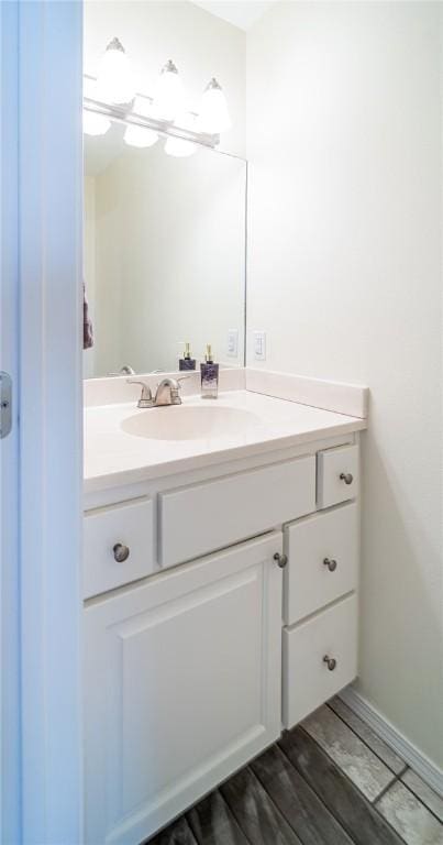 bathroom with wood finished floors and vanity