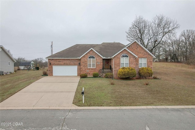 ranch-style home with brick siding, an attached garage, concrete driveway, and a front lawn