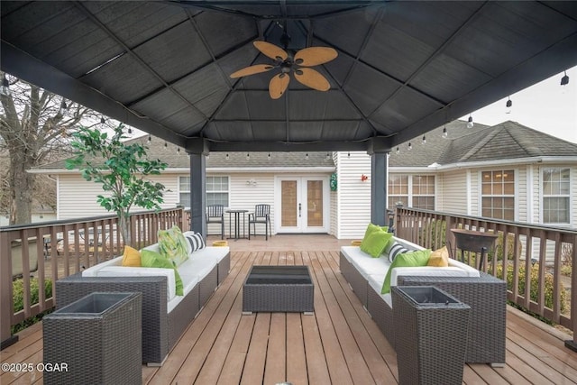 deck featuring a gazebo, french doors, an outdoor hangout area, and a ceiling fan