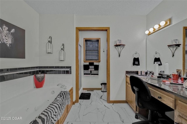 full bathroom with vanity, baseboards, a textured ceiling, a jetted tub, and marble finish floor