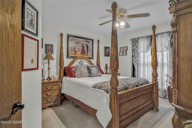 bedroom with light carpet, a textured ceiling, and a ceiling fan