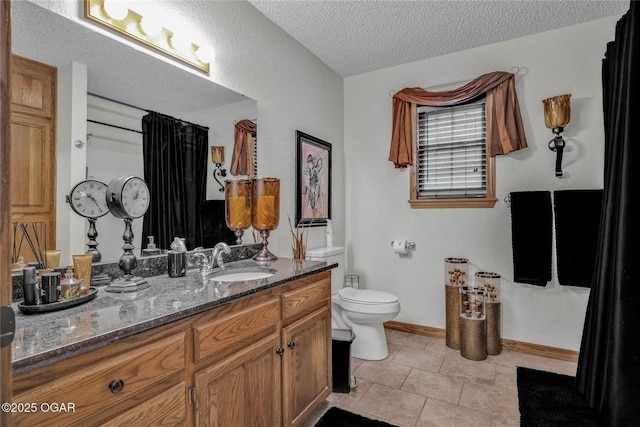 full bathroom with toilet, a textured ceiling, tile patterned flooring, baseboards, and vanity