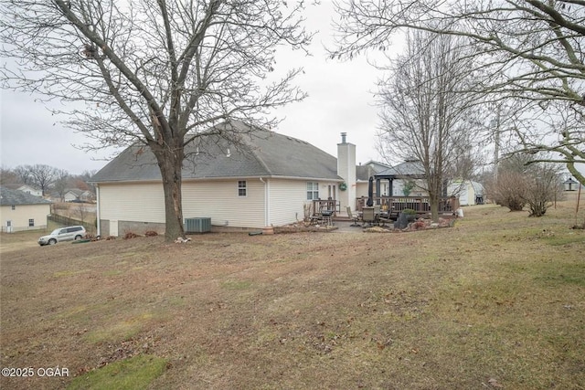 view of yard with a deck and central AC