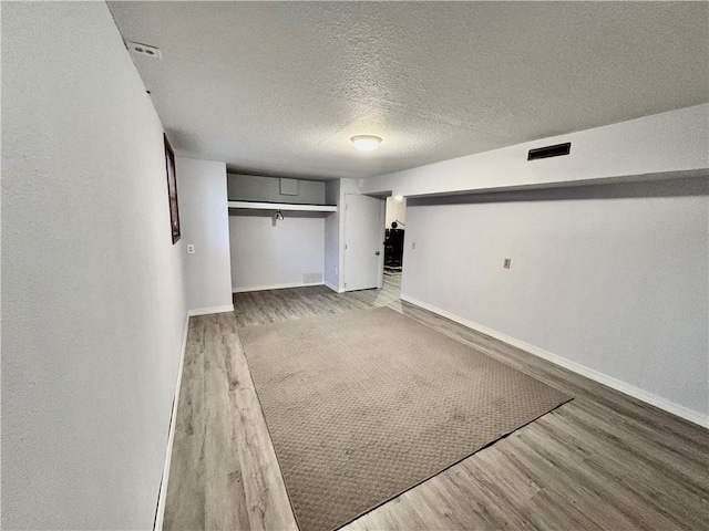 interior space with visible vents and wood finished floors