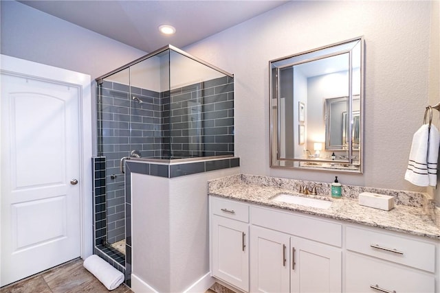 full bath with recessed lighting, a shower stall, and vanity