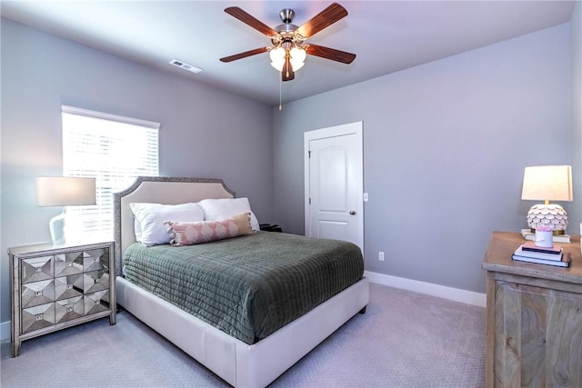 bedroom featuring visible vents, baseboards, carpet, and a ceiling fan