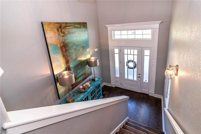 entryway featuring baseboards and hardwood / wood-style floors