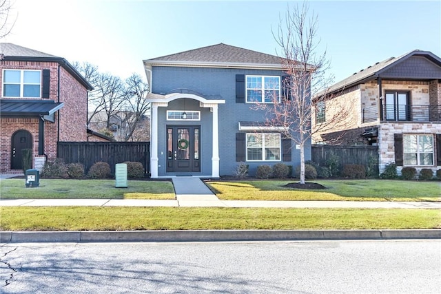 view of front of home with a front lawn and fence