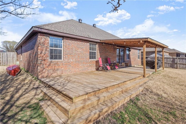 deck featuring a fenced backyard and a lawn