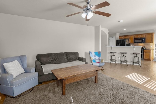 living room with recessed lighting, light tile patterned flooring, and a ceiling fan