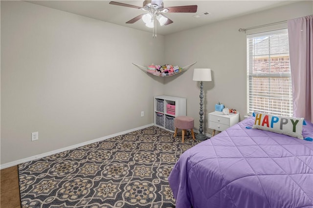 bedroom with tile patterned floors, visible vents, ceiling fan, and baseboards