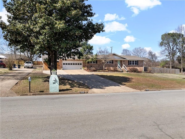 view of front of property with fence, driveway, an attached garage, a front lawn, and brick siding